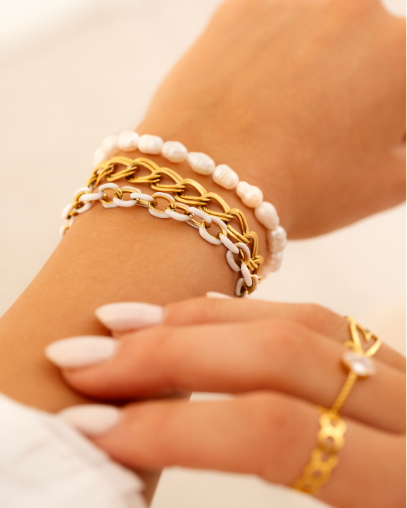 Gouden armparty met witte chains