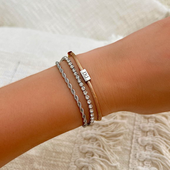 Satijnen armband in armparty met zilveren armbanden