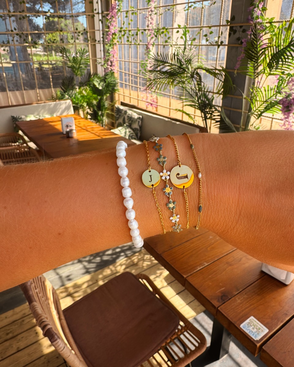 Gouden armparty met initials