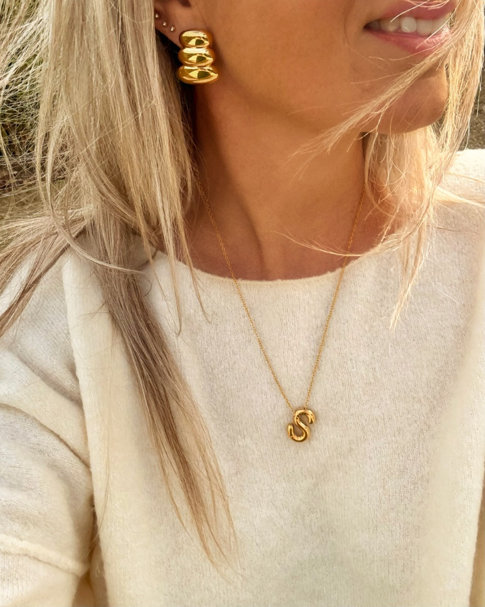 Model met letter ketting goud