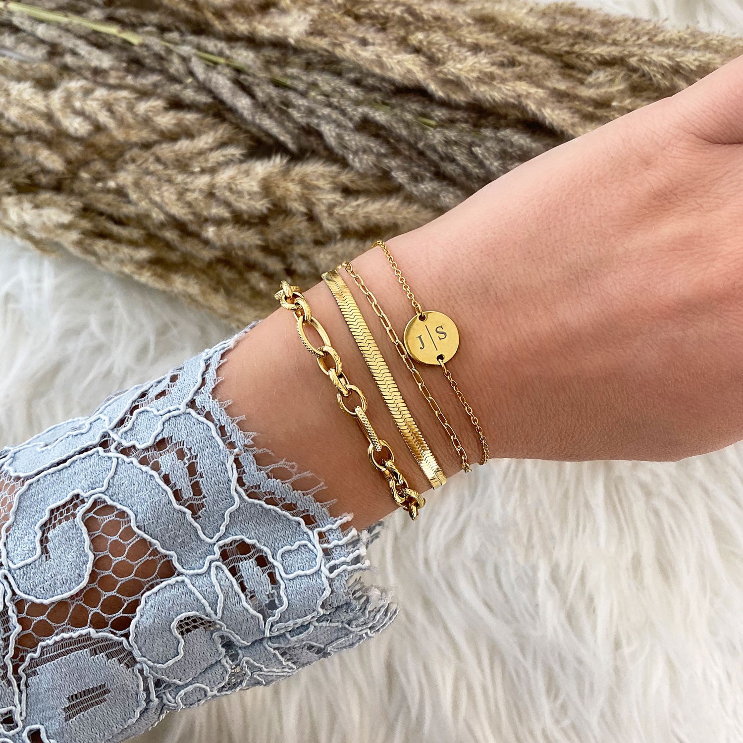 Gouden schakelarmbandjes combinatie met witte kanten top