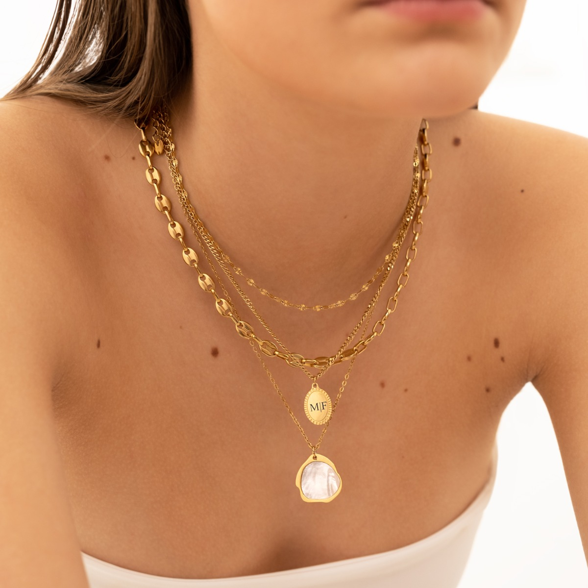 Gouden kettingen combinatie met parelmoer hanger