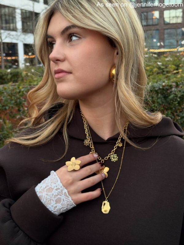 Influencer met gouden bloem ring