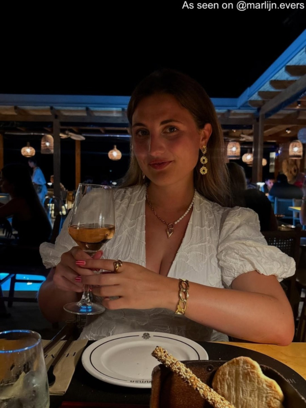 Influencer draagt lange bloem oorbellen goudkleurig
