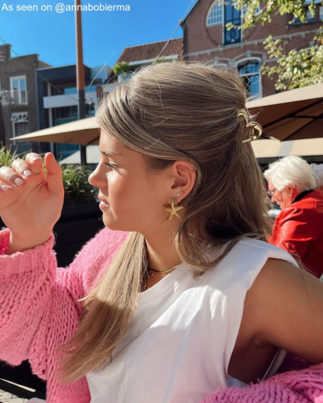 Influencer draagt gouden zeester oorbellen