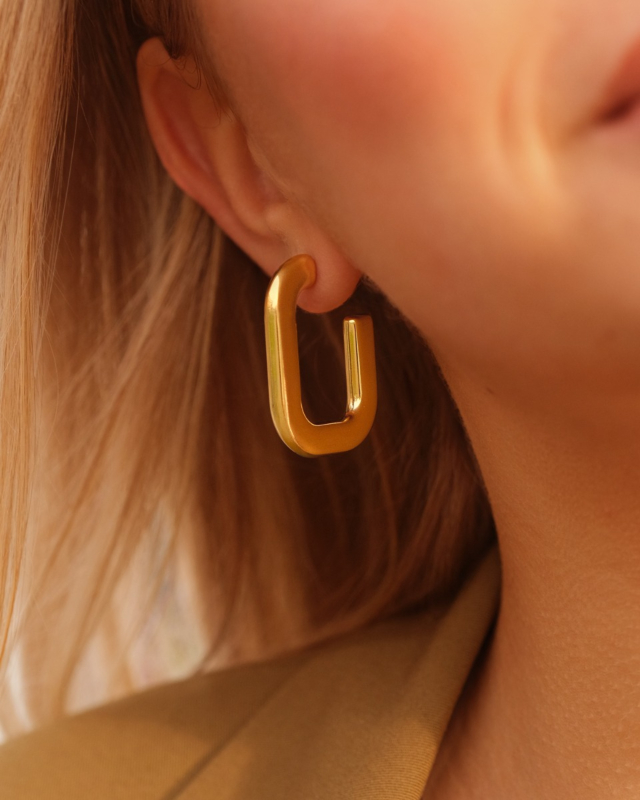 Goudkleurige oorringen bij model