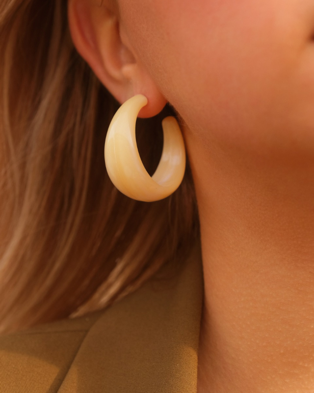 Model draagt beige oorringen