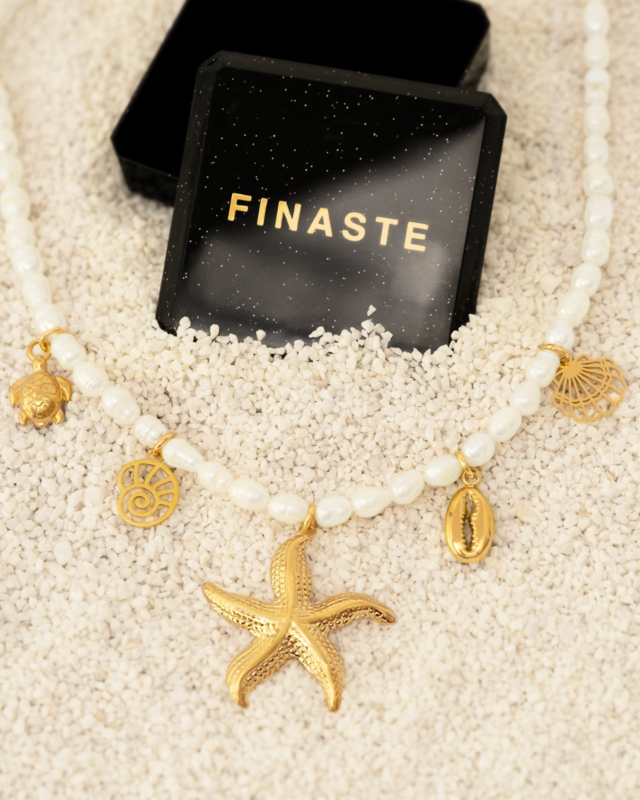parelketting met gouden bedels bij sieradendoosje