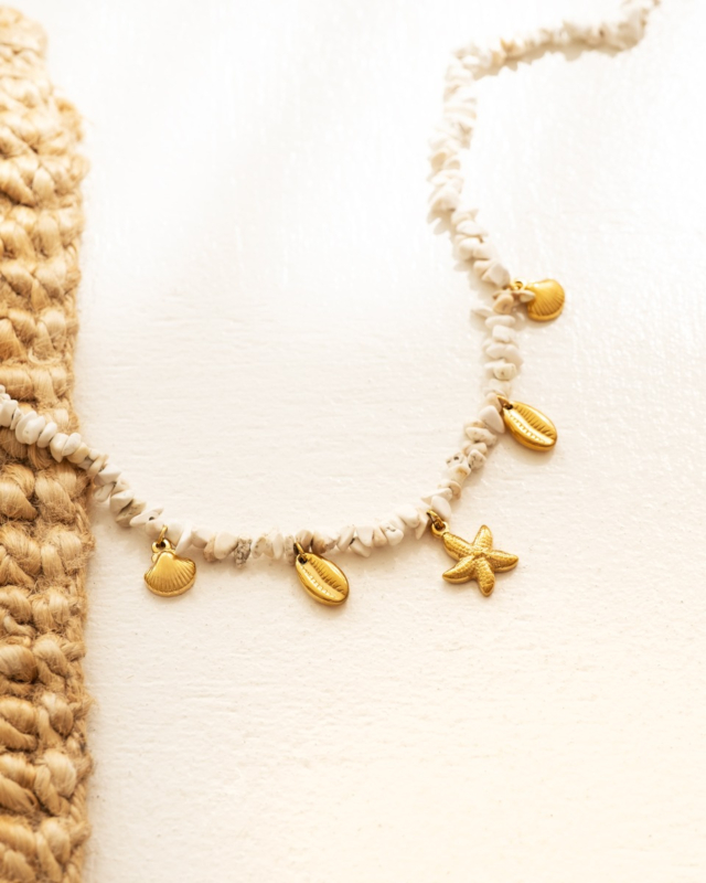 bedelketting met gouden beachy bedels en witte steentjes