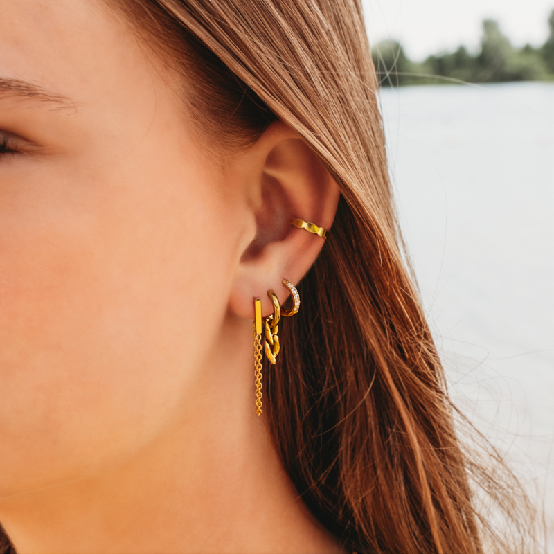 Gouden oorbellen combinatie op het strand