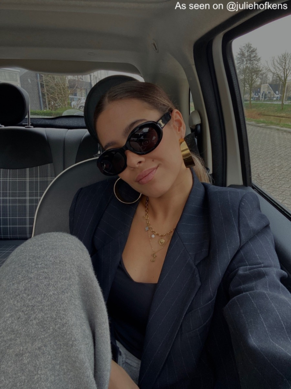 Influencer draagt gouden ketting met initial 