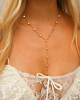 Gouden y ketting met ronde steentjes