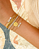 Gouden armparty met steentjes
