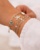 Zilveren armparty met zeester en bloemetjes