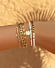 Gouden armparty met witte details