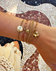 Gouden armparty met hartjes en bloemetjes
