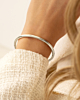 Zilveren ronde bangle om pols