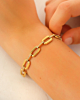 Gouden schakelarmband met steentjes