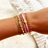 Gouden armparty met roze en gouden armbanden
