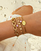 Gouden armparty met roze details