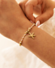 Beige touw armbandje met gouden zeester